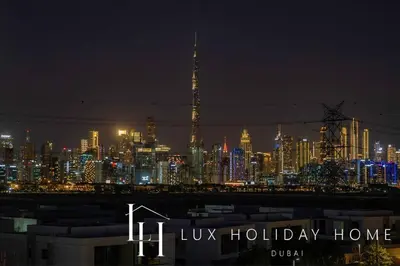 a view of a city at night with a lit up skyline at LUX The Burj Khalifa Lagoon View Suite 2 in Dubai