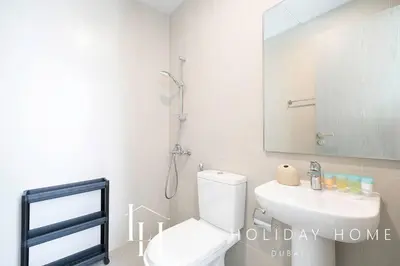a bathroom with a toilet and a sink and a mirror at LUX The Burj Khalifa Lagoon View Suite 2 in Dubai