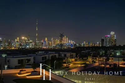 a view of a city at night with lights at LUX The Burj Khalifa Lagoon View Suite 2 in Dubai