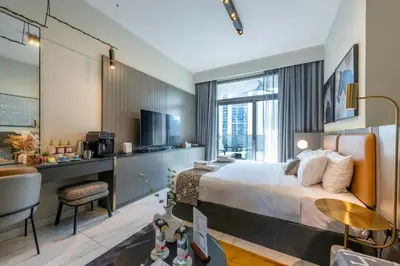 a hotel room with a bed and a desk at Canal View Studio Downtown - Near Dubai Mall & Burj Khalifa - MAG 318 in Dubai