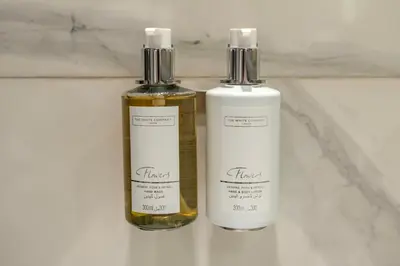 two bottles of soap sitting on a bathroom counter at Canal View Studio Downtown - Near Dubai Mall & Burj Khalifa - MAG 318 in Dubai