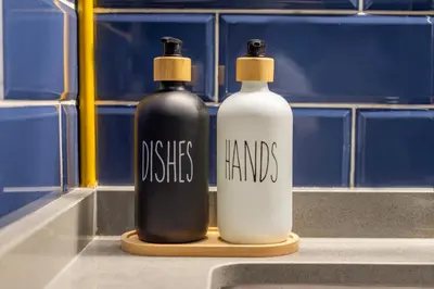 two black and white bottles sitting on a counter in a bathroom at Canal View Studio Downtown - Near Dubai Mall & Burj Khalifa - MAG 318 in Dubai