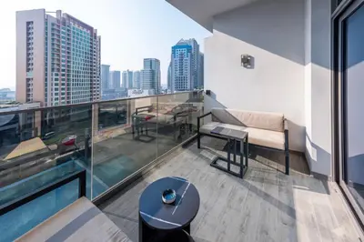 an apartment balcony with a view of the city at Canal View Studio Downtown - Near Dubai Mall & Burj Khalifa - MAG 318 in Dubai