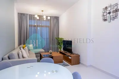 a living room with a couch and a tv at Bloomfields Modern 2br In Arabian Gate in Dubai