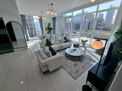 a large living room with a couch and a table at Majestic Tower in Dubai