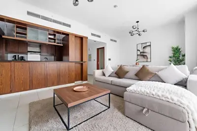 a living room with a couch and a coffee table at Spacious 1 BR Apartment Near in Dubai