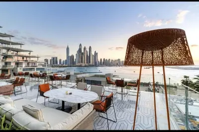 a balcony with tables and chairs and a view of the city at Five Palm Residences Sea View in Dubai