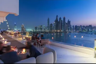 people sitting on a balcony with a view of a city at Five Palm Residences Sea View in Dubai