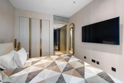 a bedroom with a bed and a flat screen tv at Five Palm Residences Sea View in Dubai
