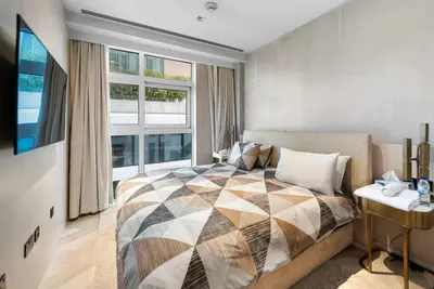 a bedroom with a bed and a large window at Five Palm Residences Sea View in Dubai