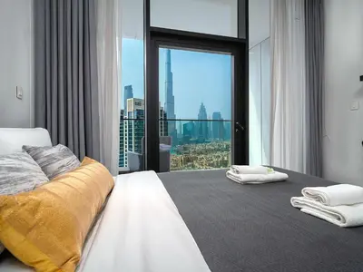 a bedroom with a bed with a view of the city at Magnificent Studio, Burj Khalifa view, Marquise Sq in Dubai
