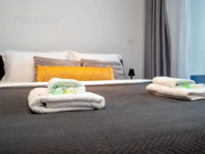 a bedroom with a bed with towels on the floor at Magnificent Studio, Burj Khalifa view, Marquise Sq in Dubai