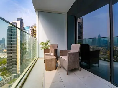 a balcony with two chairs and a view of the city at Magnificent Studio, Burj Khalifa view, Marquise Sq in Dubai