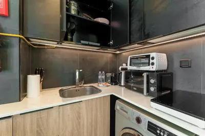 a small kitchen with a sink and a microwave at Stylish Studio with Gym & Pool Access in Dubai