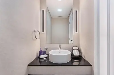 a bathroom with a sink and a mirror at Sky-High 1BR with Breathtaking Burj Khalifa View in Dubai