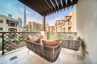 a balcony with chairs and a view of the city at Upscale 1-Bedroom Apt with Iconic Burj Khalifa View in Dubai