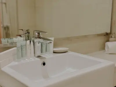 a bathroom sink with toothbrushes and toothpaste on it at Chic Studio with Balcony, Netflix and Chill Pet-free in Dubai