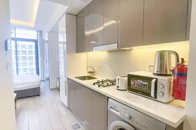 a kitchen with a counter top with a toaster oven at Chic Studio with Balcony, Netflix and Chill Pet-free in Dubai