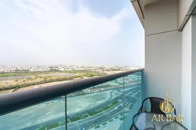 an apartment balcony with a view of an airport at Elite Residence - Premium Studio - Best Horse Course View in Dubai
