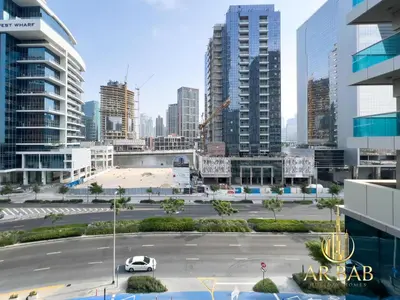 a parking lot in a city with tall buildings at Elite Residence - Premium Studio - Best Horse Course View in Dubai