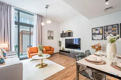 a living room with a couch and a table at Charming 3BR Townhouse with Study Room in Damac Hills 2 Centaury, Dubailand By Deluxe Holiday Homes in Dubai