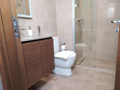 a bathroom with a toilet and a shower at Fast Wi-fi Netflix Cozy 1BR Flat Near Downtown Dubai in Dubai