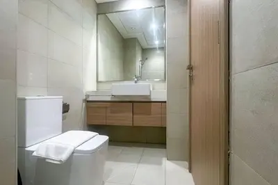 a bathroom with a toilet and a sink and a mirror at Pet free 1BR with Balcony Pool Gym Near Downtown in Dubai