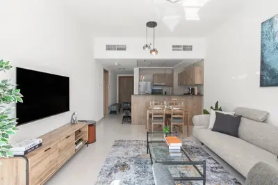 a living room with a couch and a flat screen tv at ShoresInn - Beautiful residence with Marina Views in Dubai