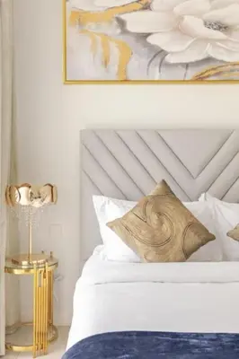 a bedroom with a white bed and a painting on the wall at LA VIE JBR, Sea & Palm View Apartment in Dubai