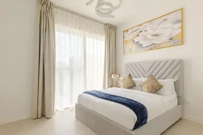 a bedroom with a bed with a large window at LA VIE JBR, Sea & Palm View Apartment in Dubai