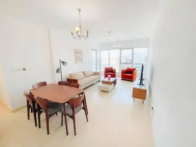 a living room with a table and a couch at Luxury Holiday Home Just Minutes from Dubai's Global Village Your Perfect Getaway!