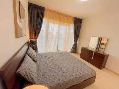 a bedroom with a bed and a large window at Luxury Holiday Home Just Minutes from Dubai's Global Village Your Perfect Getaway!