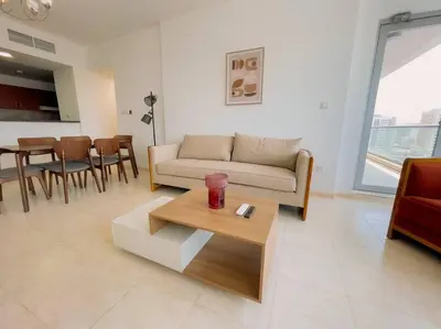 a living room with a couch and a table at Luxury Holiday Home Just Minutes from Dubai's Global Village Your Perfect Getaway!