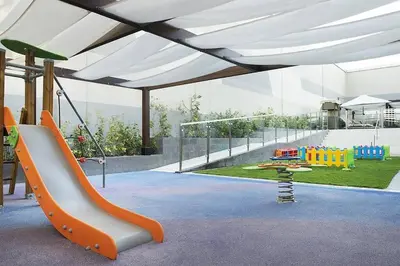 a childrens play area with a slide and a playground at In Vogue Live On the Canal in Business Bay in Dubai