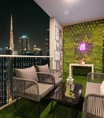 a balcony with chairs and a view of a city at Gorgeous 2BR with full Burj Khalifa view, 5 mins from Dubai Mall in Dubai