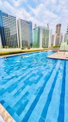a large swimming pool in a city with tall buildings at Gorgeous 2BR with full Burj Khalifa view, 5 mins from Dubai Mall in Dubai