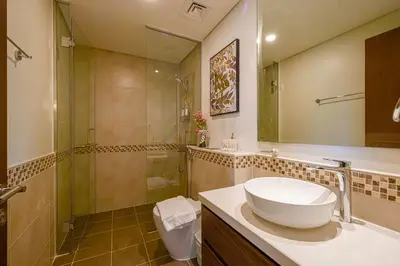 a bathroom with a sink and a shower and a toilet at Gorgeous 2BR with full Burj Khalifa view, 5 mins from Dubai Mall in Dubai