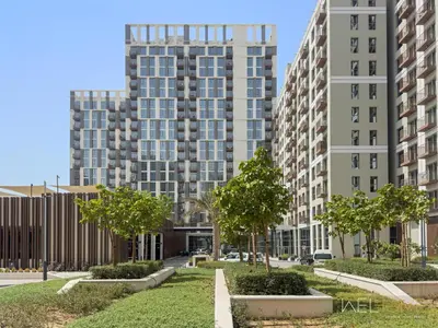 a view of two tall buildings with trees at WelHome - Beautiful 1BR Apt in Dubai Hills with City View in Dubai