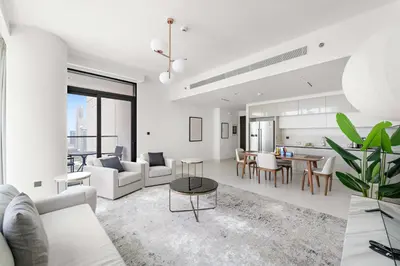 a living room with white furniture and a table at Silkhaus Family Ideal & High Floor 2BDR in Dubai