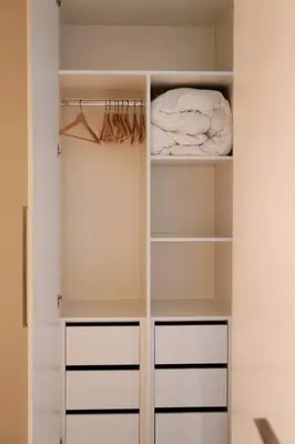 a white closet with white shelves and a vase at Luxury Downtown Dubai Burj Khalifa & Fountain View in Dubai