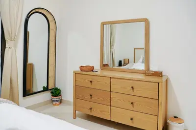 a bedroom with a dresser with a mirror on it at Luxury Downtown Dubai Burj Khalifa & Fountain View in Dubai