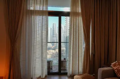 a room with a window with a view of a city at Luxury Downtown Dubai Burj Khalifa & Fountain View in Dubai