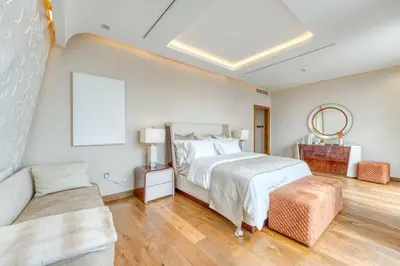 a white bedroom with a bed and a couch at World Class Luxurious 6 BDR Villa In Palm Jumeriah in Dubai