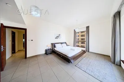 a bedroom with a bed and a large window at Jumeirah Beach Residence - Bahar 1, Dubai Marina in Dubai