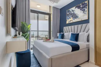 a bedroom with a king sized bed with blue walls at Frank Porter - Aykon City Tower in Dubai