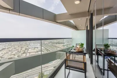 a room with glass walls and a view of a city at Frank Porter - Aykon City Tower in Dubai