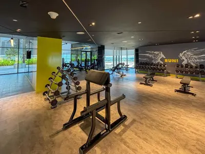 a gym with treadmills and ellipticals in a building at Frank Porter - Aykon City Tower in Dubai