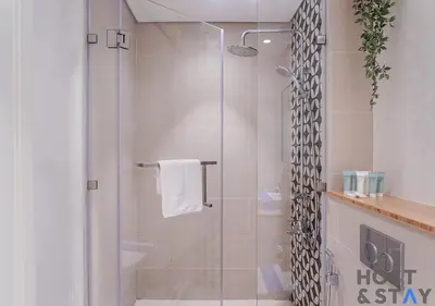 a shower with a glass door in a bathroom at Upgraded 2BR In Dubai Hills in Dubai