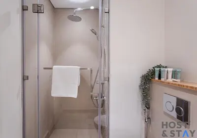 a shower with a glass door in a bathroom at Modern 1bed Haven in Dubai Hills in Dubai