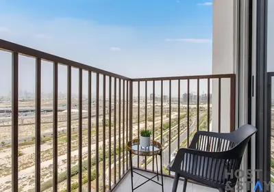 a balcony with a chair and a table at Amazing 2BR in Collective 2 in Dubai